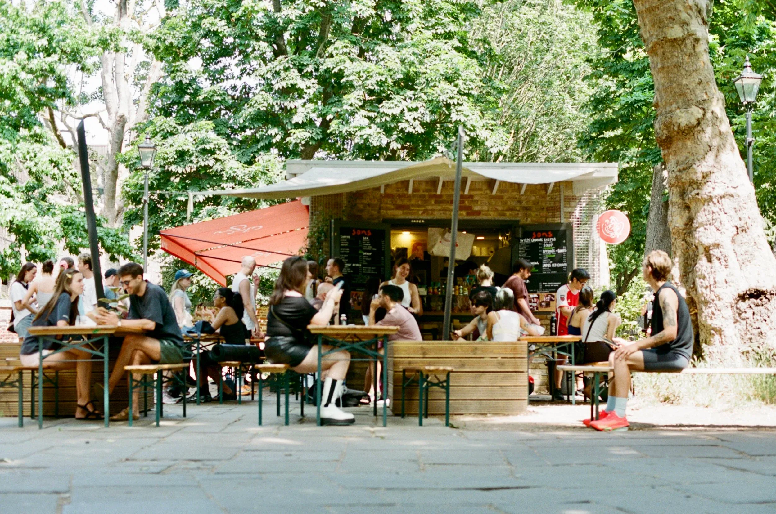 Busy tables outside the sons kiosk in the courtyard